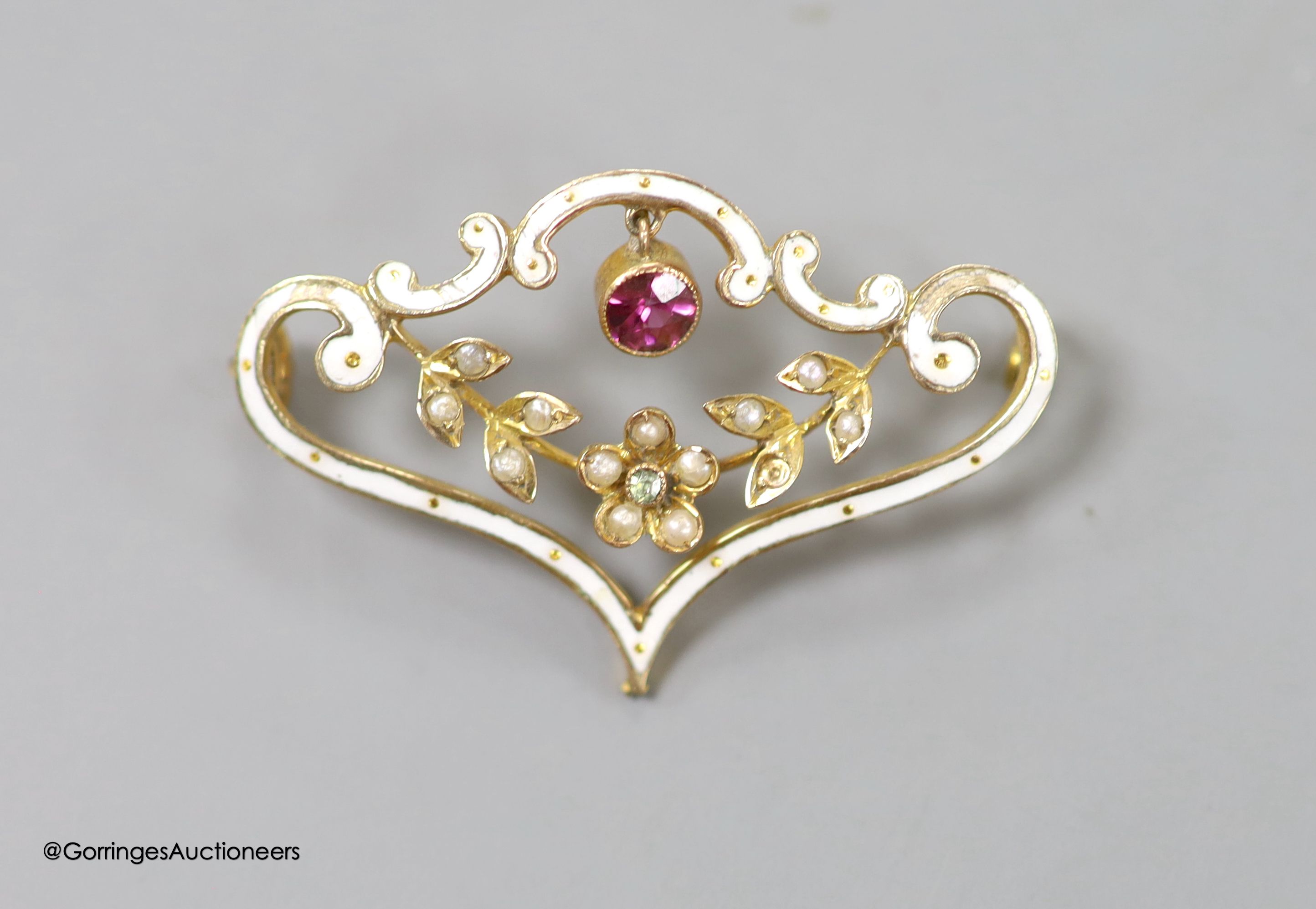 An Edwardian 9ct, enamel, seed pearl and gem set drop scroll brooch, 33mm, ross weight 2.6 grams(a.f.).
